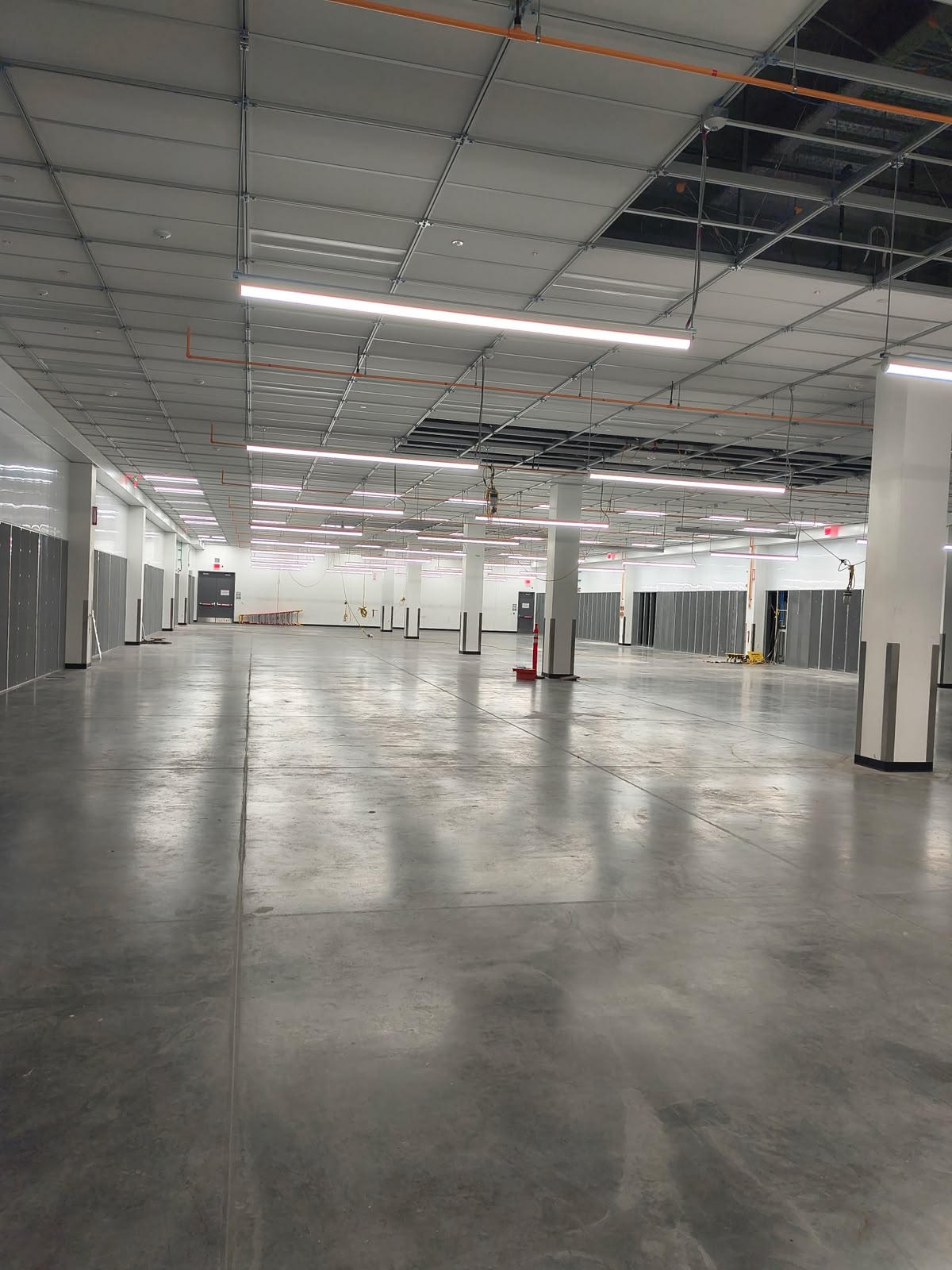 Finished, empty data center hall with polished floors awaiting turnover