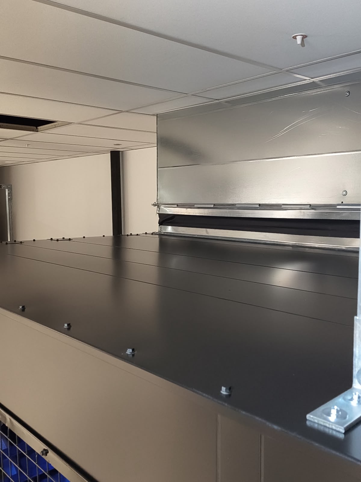 Clean overhead containment and ductwork detail inside a finished technical space